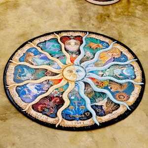May include: A circular jigsaw puzzle with a sun and moon motif at its core, encircled by zodiac symbols. The puzzle has a black edge and incorporates colours such as blue, yellow, and brown. The zodiac signs are illustrated with intricate details.