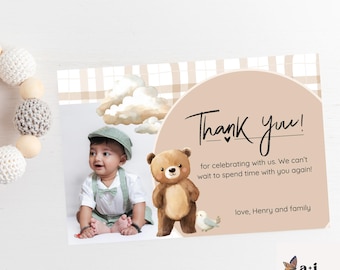 May include: A wooden baby rattle with crochet and wooden beads is next to a thank you card. The card features a baby, a teddy bear, and the words "Thank you!" with a message and the name "Henry".