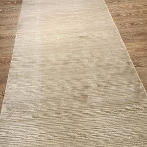 May include: A long, rectangular runner rug featuring a light grey colour palette. The surface of the rug displays a consistent, fine-textured horizontal line pattern that runs across the entire length of the piece, creating a uniform appearance.