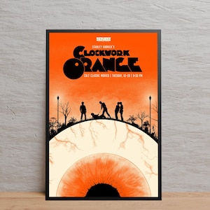 May include: Framed poster with an orange backdrop, featuring the text "CLOCKWORK ORANGE" and silhouettes of people. The poster includes the text "CULT CLASSIC MOVIES | TUESDAY, 12-29 | 9:30 PM". The bottom of the poster has an eye graphic.