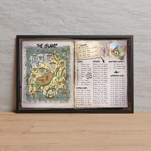 May include: Framed artwork featuring a detailed map titled "THE ISLAND." The map is hand-drawn with a vintage aesthetic, showcasing various locations and points of interest. Accompanying text provides legends, artifact locations, and underwater layers. The frame is black.