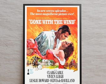 May include: A framed movie poster for "Gone With The Wind" featuring Clark Gable and Vivien Leigh. The poster has an orange and yellow background with the film's title and cast names. The image shows a man holding a woman.