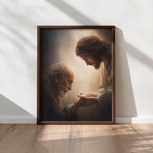 May include: A framed print depicts a tender moment between two figures. One figure, with a long beard, is holding hands with another figure. The artwork is in warm tones, with a focus on the figures' faces and hands.