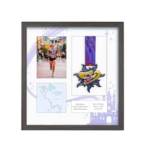 May include: Framed display featuring a photo of a runner, a race map, and a gold and purple medal. The medal has a sun-like design with a purple ribbon. The frame is gray and includes text: RunDisney Princess Marathon Half Marathon.
