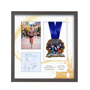 May include: Framed display featuring a marathon medal with a blue ribbon, a photo of a runner, and a map. The medal has a colorful design with cartoon characters. The frame includes text: "RunDisney Marathon Weekend Full Marathon".