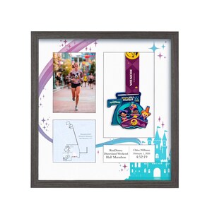 May include: Framed display featuring a photo of a runner, a race map, and a RunDisney Half Marathon medal. The medal has a blue and purple design with cartoon characters. The frame is gray.