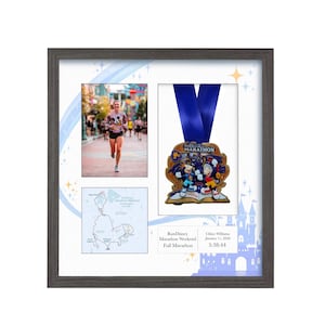 May include: Framed display with a marathon medal and blue ribbon, a photo of a runner, and a map. The medal features cartoon characters. The gray frame surrounds the images.