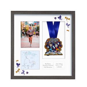 May include: A framed display featuring a photo of a runner, a marathon medal, and a map. The medal has a blue ribbon and a colorful design. The frame is gray with decorative dragon and crown accents.