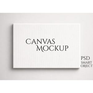 Puede incluir: Una maqueta de lienzo rectangular blanco con las palabras "CANVAS MOCKUP" en negro. Las palabras "PSD SMART OBJECT" están en la esquina inferior derecha. El lienzo está sobre un fondo blanco.