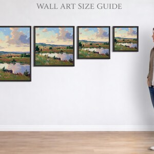 Puede incluir: Cuatro impresiones art&iacute;sticas enmarcadas de paisajes con una serena escena de lago, expuestas en una pared blanca. Las impresiones var&iacute;an en tama&ntilde;o, mostrando una pintura de un lago, &aacute;rboles y un cielo nublado. Una mujer est&aacute; al lado del arte, con una referencia de altura de aproximadamente 165 cm.