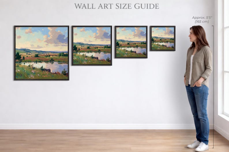 Puede incluir: Cuatro impresiones art&iacute;sticas enmarcadas de paisajes con una serena escena de lago, expuestas en una pared blanca. Las impresiones var&iacute;an en tama&ntilde;o, mostrando una pintura de un lago, &aacute;rboles y un cielo nublado. Una mujer est&aacute; al lado del arte, con una referencia de altura de aproximadamente 165 cm.