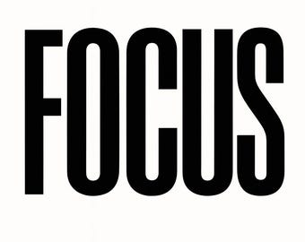 May include: The word "FOCUS" is displayed in large, bold, black capital letters on a white backdrop. The typeface is a thick, sans-serif style. The image is a straightforward and impactful visual.