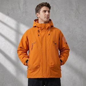 May include: A bright orange hooded jacket featuring a high collar, a front zipper closure with a protective placket, two slanted chest pockets with zippers, and two large lower pockets. The sleeves have adjustable cuffs with black hook-and-loop tabs.