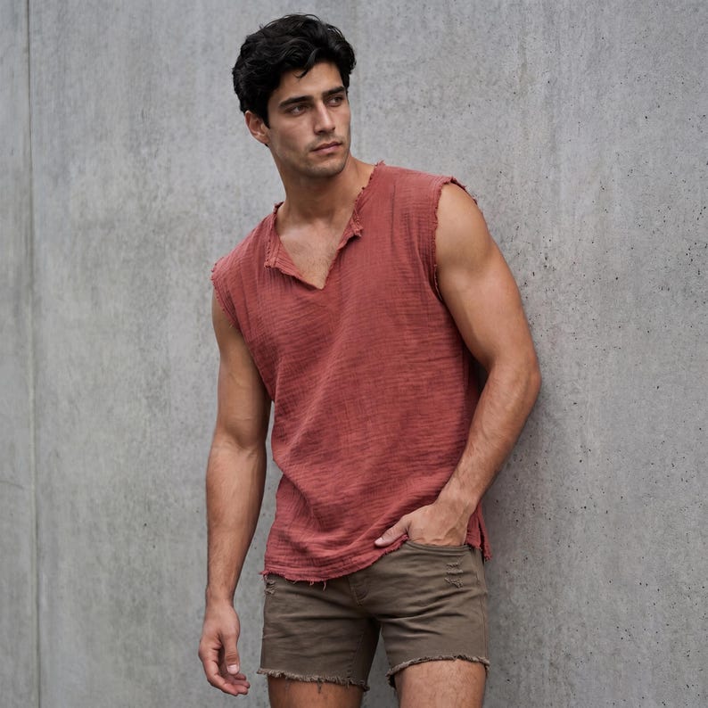 May include: A sleeveless, brick-red top with a V-neck and distressed edges. Paired with brown shorts with frayed hems. The outfit is casual and relaxed, suitable for warm weather.