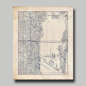 May include: A vintage map of Chicago, Illinois, printed in blue ink on a beige background. The map shows the city's streets, waterways, and landmarks.