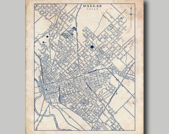 May include: A vintage style map of Dallas, Texas, printed in blue ink on a cream colored background. The map shows the city's streets and landmarks.