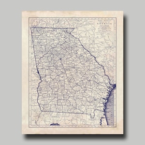 May include: A vintage map of the state of Georgia, printed in blue ink on a cream-colored background. The map shows the state's counties, cities, and major roads. The map is titled "Rand McNally Road Map of Georgia".