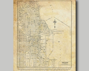 May include: A vintage map of Chicago, Illinois, showing the central part of the city. The map is printed on aged paper and features a compass rose and a key with points of interest. The text "CHICAGO" is printed in the bottom right corner of the map.