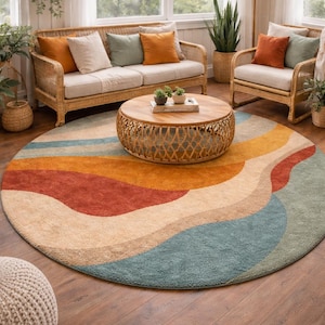 May include: A circular rug featuring a wave pattern in beige, orange, red, and teal. The rug is in a living room with wicker furniture and a wooden coffee table. The rug's diameter is approximately 213 cm.