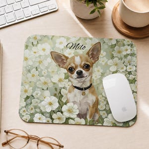 May include: A rectangular mouse pad featuring a tan and white Chihuahua wearing a black collar with a gold tag, centred against a background of white flowers and green foliage. The name Milo is printed in black script above the dog's head.