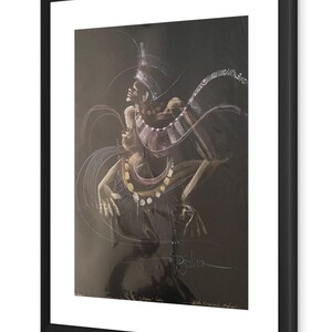 May include: A framed charcoal artwork depicting figures with elaborate jewellery and headdresses. The drawing uses black, white, and gold tones, with fluid lines suggesting motion. The frame is black, and the artwork has a signature.