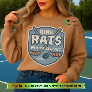 Puede incluir: Una sudadera color canela con un diseño de hockey azul y blanco. El diseño dice "Rink Rats Winter Classic" e incluye palos de hockey y un disco. El texto "PNG File - Digital Download Only (No Physical Item)" está en la parte inferior.