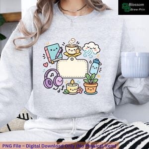 May include: A light grey sweatshirt with a colourful graphic of cute illustrations: a notebook, coffee cup, cloud, water bottle, headphones, candle, and potted plant. It has a blank label for customisation.