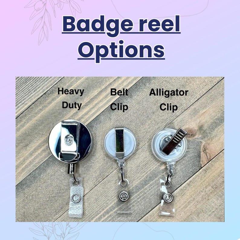 May include: Image showing three badge reel options: Heavy Duty, Belt Clip, and Alligator Clip. The text "Badge reel Options" is at the top. The reels are on a light brown wooden surface.
