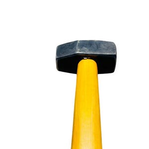 May include: A sledgehammer featuring a black, octagonal head and a vibrant yellow wooden handle. The handle tapers towards the base. The head is made of a dark, metallic material. This tool is designed for demolition and construction.