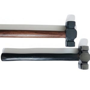May include: Two hammers with dark metal heads and wooden handles are shown against a white backdrop. One hammer has a dark brown handle, the other a black handle. These hammers are for construction or woodworking.