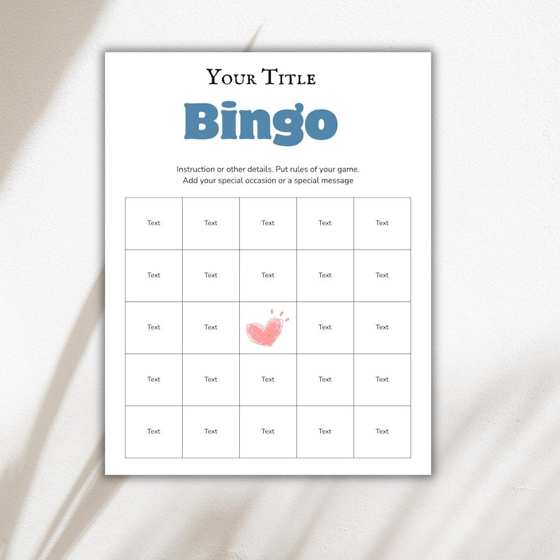 May include: A printable Bingo game template on white paper. The title "Bingo" is in blue, with space for a custom title above. The grid has 25 blank squares for text, with a pink heart graphic in the center.