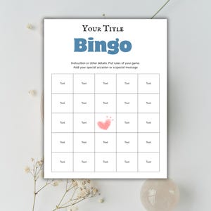 May include: A white Bingo game card with the title "Your Title" and the word "Bingo" in blue. The card has a grid of boxes labeled "Text" and a pink heart graphic. Instructions are included.