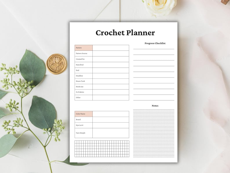 May include: A white Crochet Planner with sections for pattern details, progress checklist, and notes. The planner includes spaces for yarn information and a grid for tracking. The title "Crochet Planner" is in bold black font.