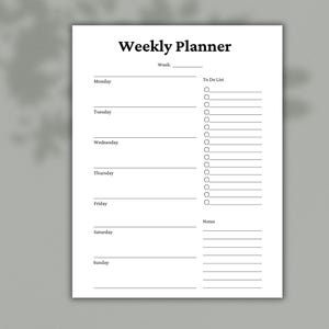 May include: A white weekly planner with the title "Weekly Planner" in bold black font. The planner includes sections for each day of the week, a "To Do List," and space for notes. The background is a light gray.