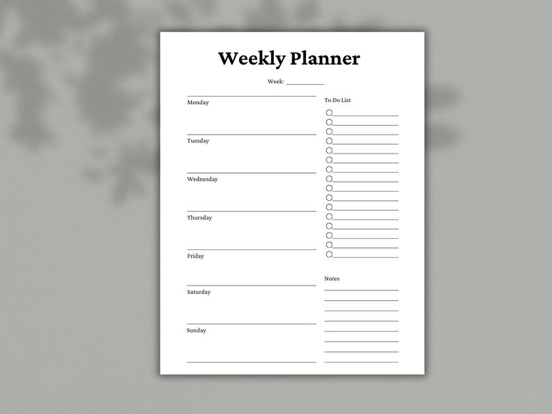 May include: A white weekly planner with the title "Weekly Planner" in bold black font. The planner includes sections for each day of the week, a "To Do List," and space for notes. The background is a light gray.