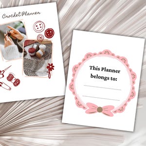 May include: Two white pages with a crochet theme. One page has the text "Crochet Planner" and images of crochet tools and projects. The other page has a pink decorative border with the text "This Planner belongs to:" and space for a name.