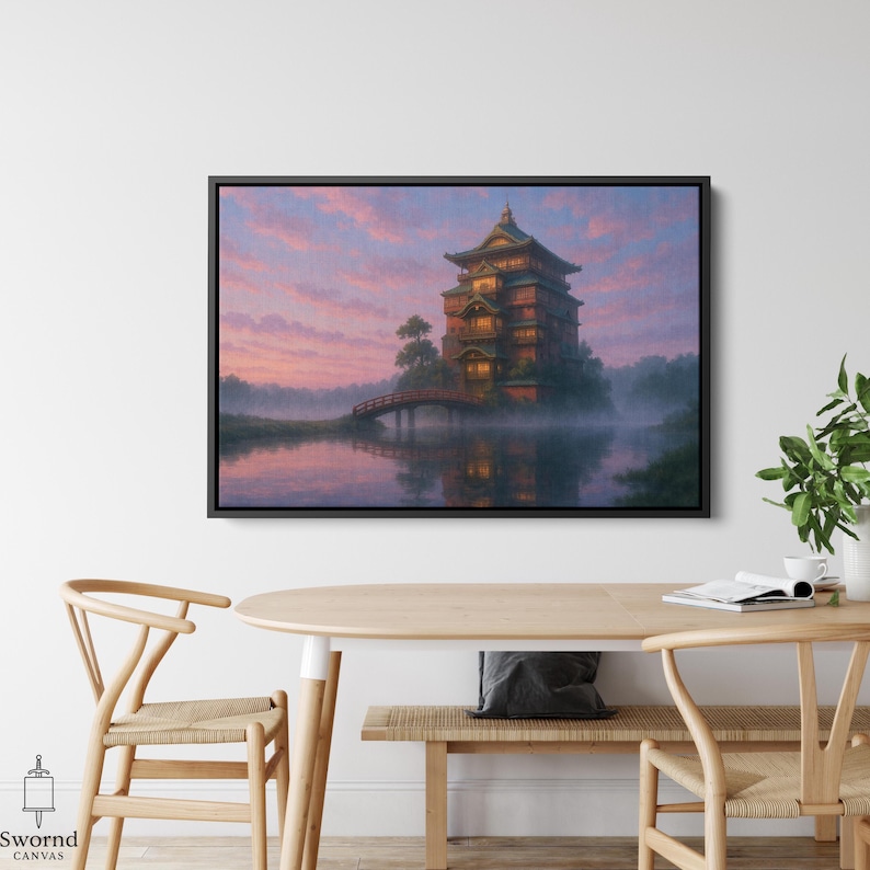 May include: A framed canvas print depicts a Japanese-style building on an island, connected by a red bridge. The artwork features a serene lake, lush trees, and a vibrant sunset with pink and purple hues. The canvas is framed in black.