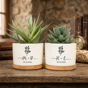 May include: A set of three ceramic mugs with a speckled, matte finish. The mugs are in shades of cream, light gray, and dark gray. Each mug has a simple, minimalist design, perfect for coffee or tea.