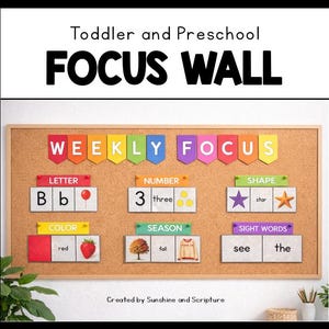 May include: A corkboard educational display for toddlers and preschoolers, labelled "FOCUS WALL". It features sections for letters, numbers, shapes, colours, seasons, and sight words, with corresponding images and text. The text reads "Weekly Focus".