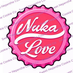 May include: A pink bottle cap design with the words "Nuka Love" in white script. The bottle cap has a scalloped edge and a darker pink border. The design is centered on a white background.