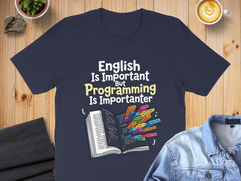 T-shirt with "English Is Important Programming Is Importanter" text and code snippets.
