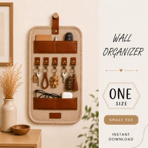 May include: A beige fabric wall organiser with brown leather-like pockets and five metal hooks for keys. The organiser features a top hanging strap and includes text that reads WALL ORGANIZER, ONE SIZE, SINGLE FILE, and INSTANT DOWNLOAD.