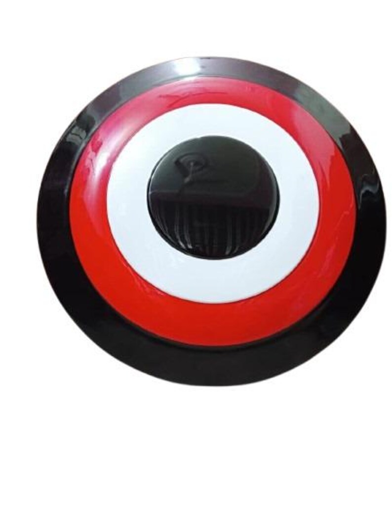 May include: A round shield with a black, red, white, and black color scheme. The shield has a central black circle with a raised center, surrounded by white and red concentric rings. The outer edge is black.