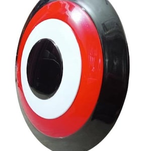 May include: A glossy, circular shield with a black outer rim, a red middle ring, and a white inner ring surrounding a central black circle. The shield has a slightly convex shape.