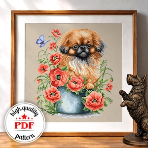 May include: Cross-stitch pattern of a Pekingese dog surrounded by red poppies in a blue vase, with a blue butterfly. The artwork is framed in a wooden frame. The image includes a circular logo that says "high quality PDF pattern".