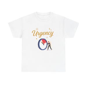 May include: White t-shirt with the word "Urgency" in gold script, a clock graphic with a red hand, and a small figure pushing the clock hand. The design includes sun and starburst accents.
