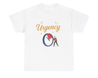 May include: White t-shirt featuring the word "Urgency" in gold script, a clock graphic with a red hand, and a small figure pushing the clock hand. The design includes sun and starburst accents.