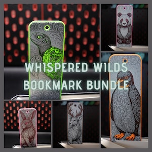 Könnte beinhalten: Eine Sammlung dekorativer Lesezeichen mit Tierillustrationen. Die Lesezeichen zeigen eine Schildkröte, einen Panda, einen Pinguin, ein Kaninchen und einen Hirsch, jeweils mit aufwendigen Designs und einem Loch für einen Quasten. Der Text "Whispered Wilds Bookmark Bundle" ist zu sehen.