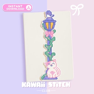 May include: A cross-stitch bookmark featuring a whimsical design. The bookmark showcases a purple lamppost with a bird on top, pink bow, and a cute pink cat at the bottom. The text "KAWAII STITCH CLUB" is at the bottom.