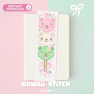 May include: A cross-stitch bookmark featuring three stacked bear faces in pink, cream, and green, with floral accents. The bookmark has the text "INSTANT DOWNLOAD" and "KAWAII STITCH CLUB".